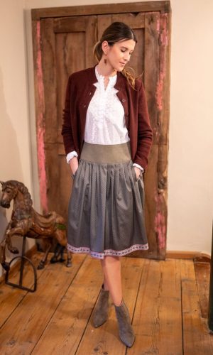 Dame mit Trachtenrock in dunkelbraun mit breitem Bund, weiße Bluse mit rostbrauner Jacke und Lederschuhen
