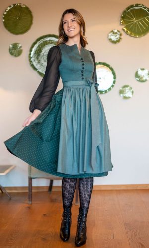 Dame mit schwarzer langarm Bluse und geschlossenem Petrol Dirndl knielang